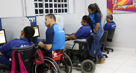 Fotografia em plano médio capturada em um escritório ou telecentro, mostrando cinco pessoas unif...